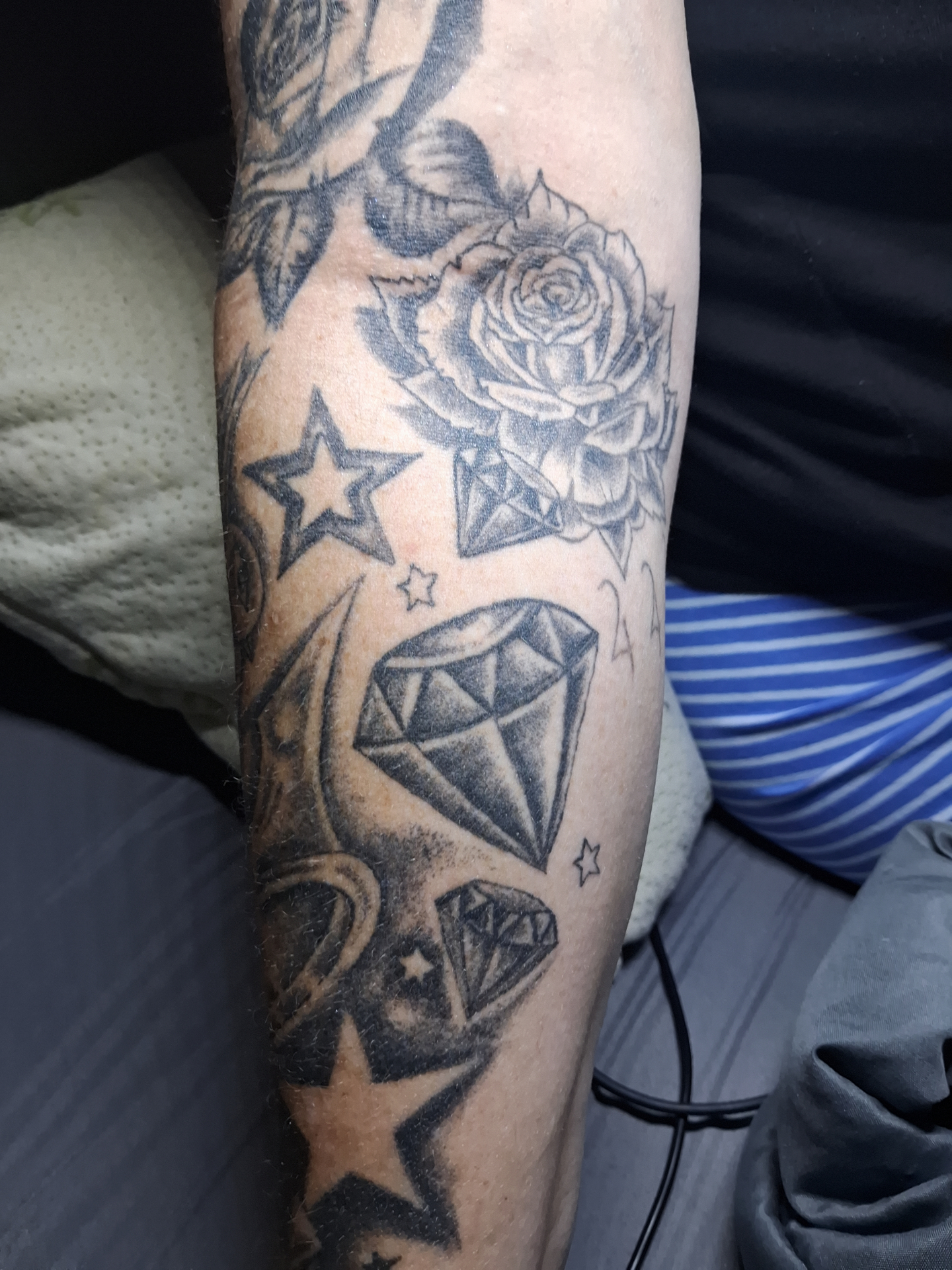Rose, diamonds and stars forearm tattoo
