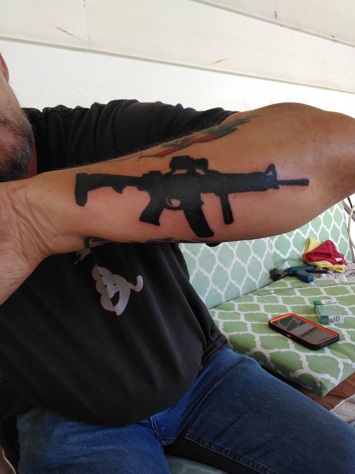 Blackout rifle silhouette forearm tattoo
